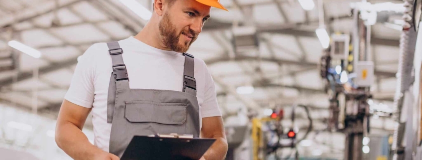 Workman at store house in orange helmet